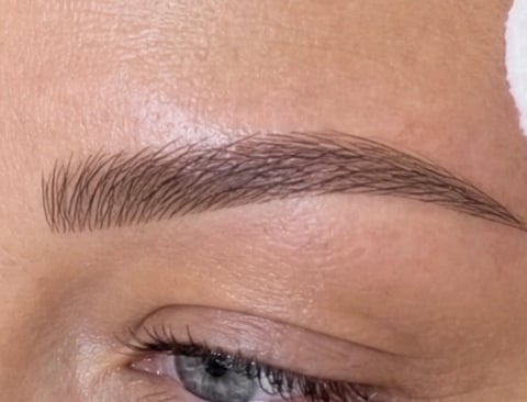 Microblading in progress in Bradenton, Florida — precise eyebrow hair strokes being added at CC Styling Studio