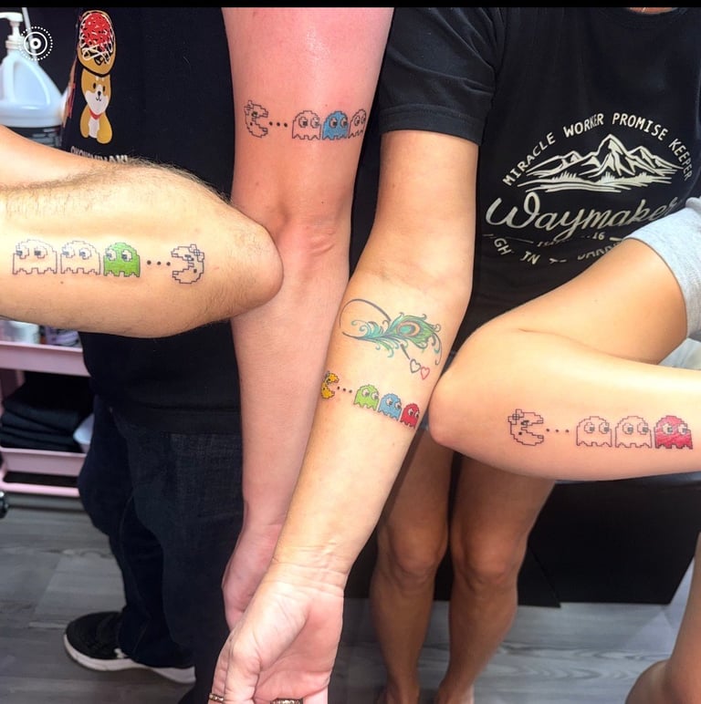 Group of people displaying matching Pac-Man video game character tattoos on their arms and legs