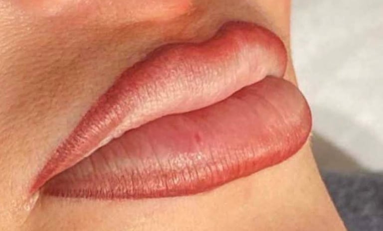 Close-up of two lip color swatches showing matte pink and deep burgundy shades on skin at CC Styling Studio Bradenton FL