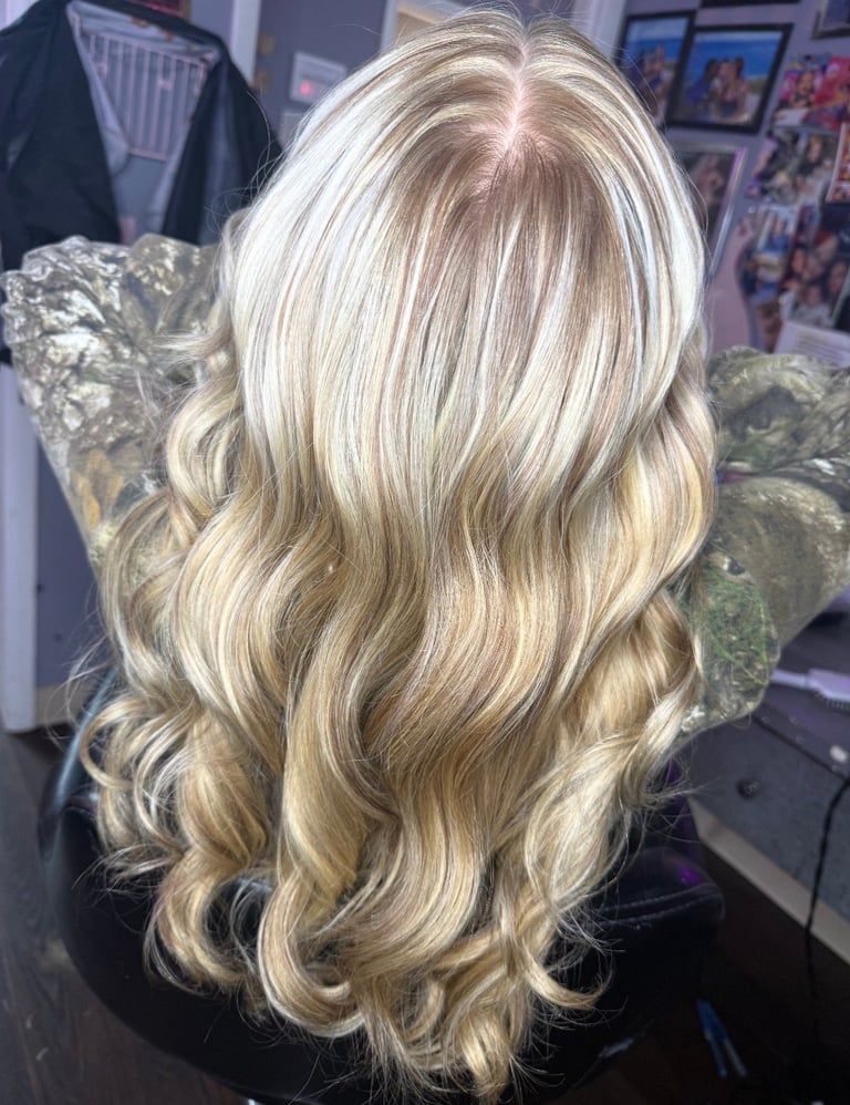 Blonde specialist full foil highlight at CC Styling Studio in Bradenton, FL — back view of long wavy blonde hair with highlights styled on a salon display head