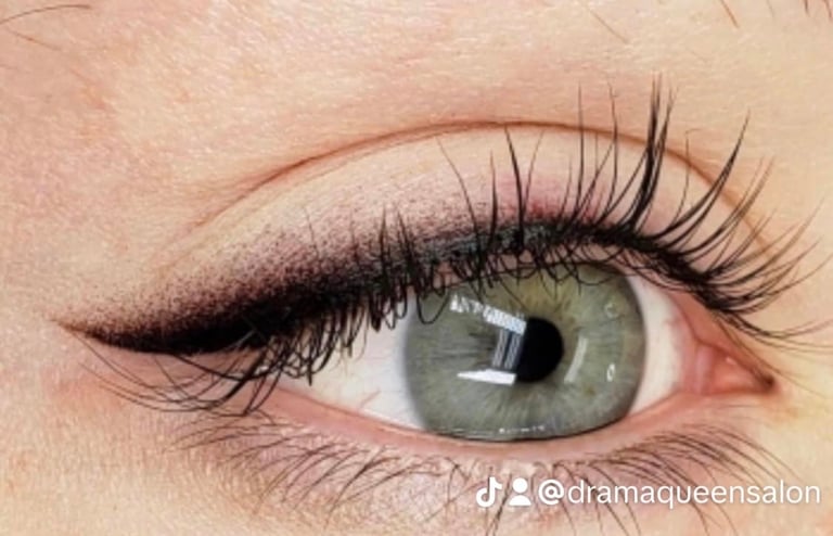 Close-up of a womans eye with green iris, dramatic black winged eyeliner, and dark mascara on long lashes at CC Styling Studio Bradenton FL