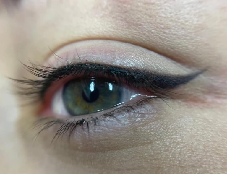Close-up of eye makeup featuring green-hazel iris, winged black eyeliner, and defined eyebrow at CC Styling Studio Bradenton FL