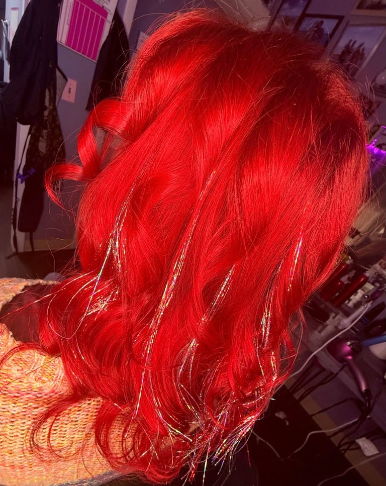 Full color red hair with Fairy Hair at CC Styling Studio in Bradenton, FL — vibrant red hair with silver highlights styled in waves and curls