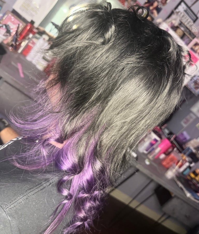 Black hair with purple tips at CC Styling Studio in Bradenton, FL — long gray and silver hair with purple-tinted ends styled in a salon