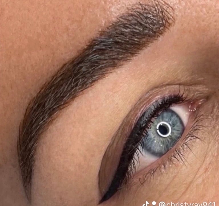 Powder brow defined makeup look — bold, sculpted permanent eyebrow paired with black eyeliner and mascara for a full glam finish at CC Styling Studio in Bradenton, FL
