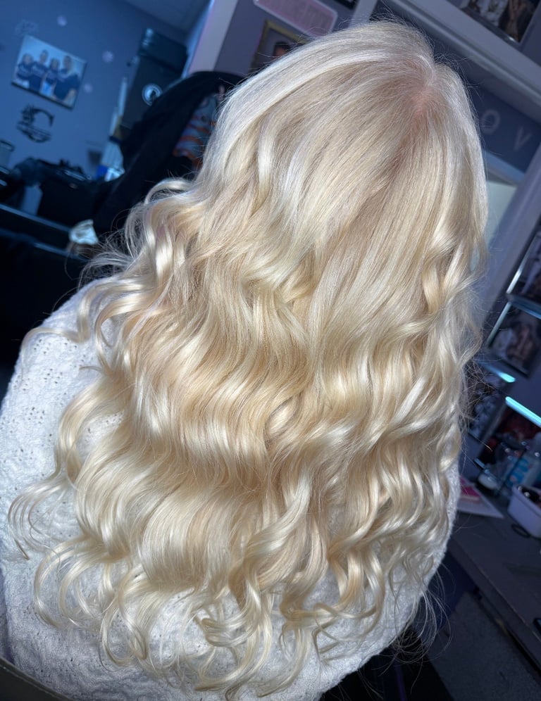 Beautiful blonde hair transformation by a blonde specialist at CC Styling Studio in Bradenton, FL — long platinum blonde voluminous curls with blonde highlights