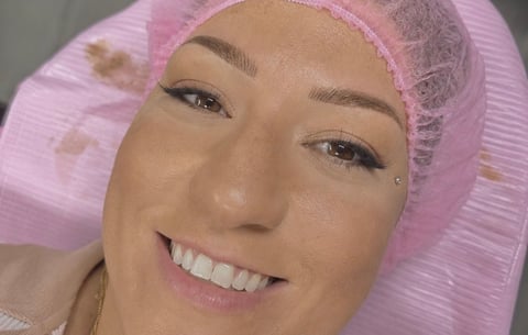 Client smiling during her permanent eyebrow appointment in Bradenton, Florida at CC Styling Studio