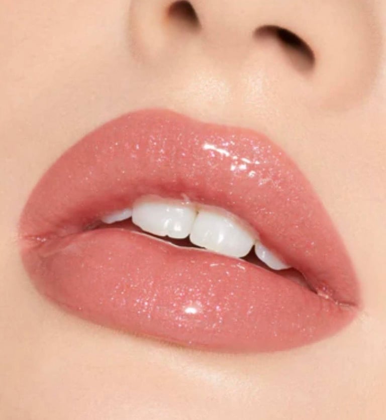 Close-up of glossy mauve-pink lips with white teeth visible and smooth skin at CC Styling Studio Bradenton FL