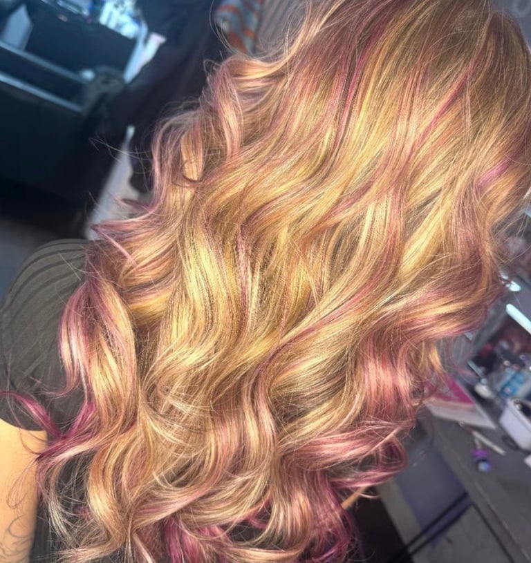 Golden blonde and rose gold balayage highlights on long wavy hair in Bradenton, Florida by CC Styling Studio